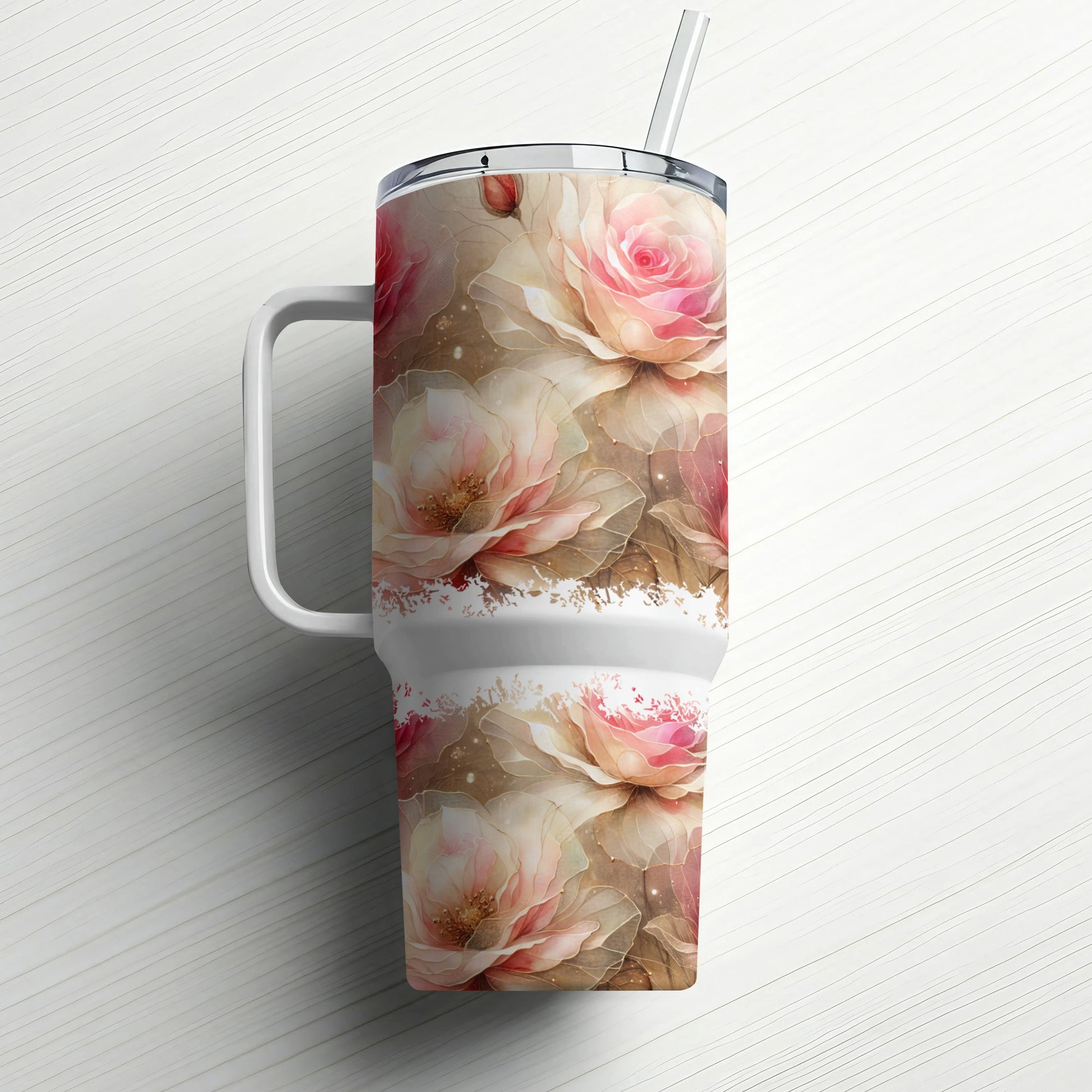 Large insulated tumbler with pink roses and a straw.