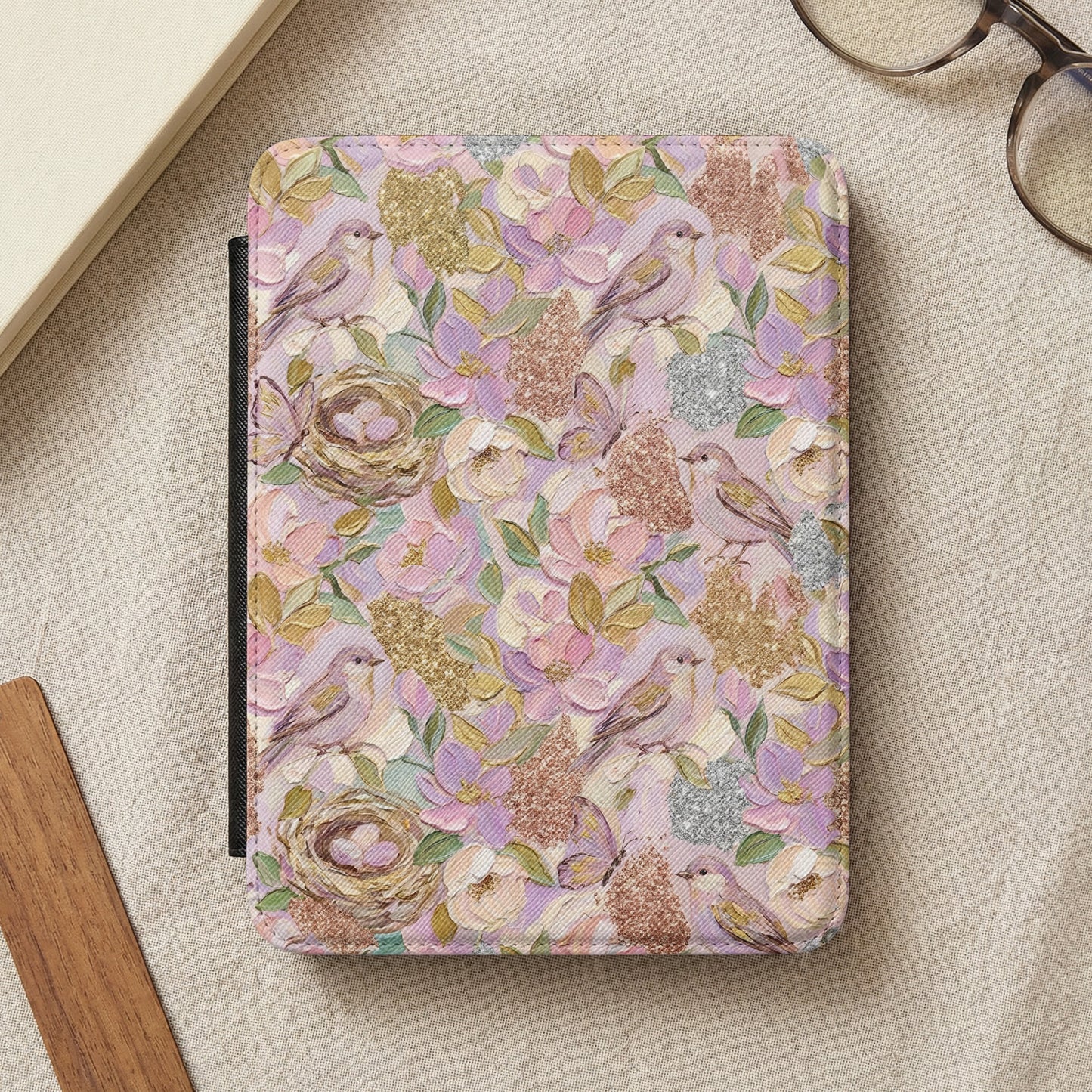 E-reader cover with a floral and bird pattern in pastel colors.
