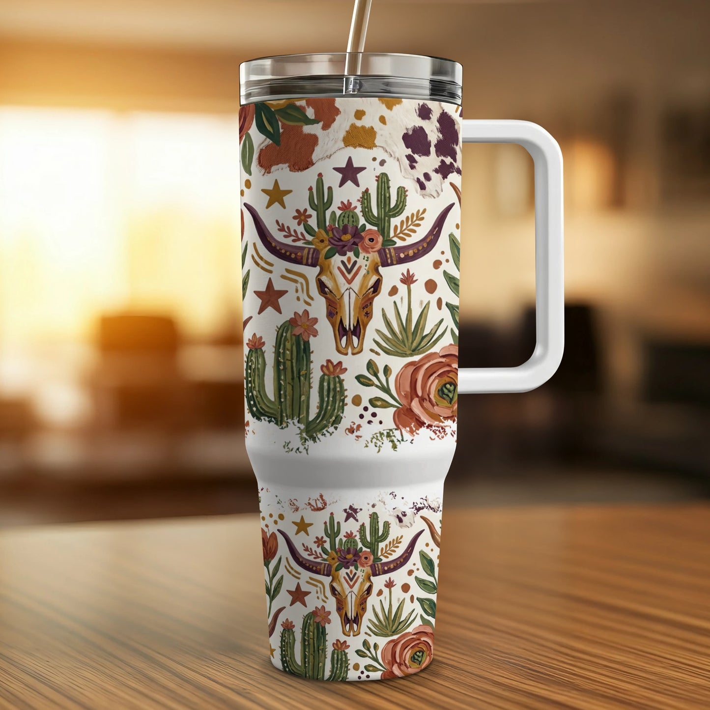 Cowhide and floral patterned tumbler with steer skull and cactus designs.