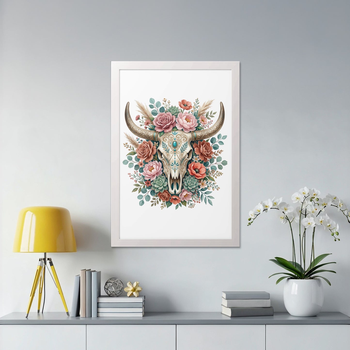 Framed artwork of a bull skull adorned with colorful flowers and foliage.