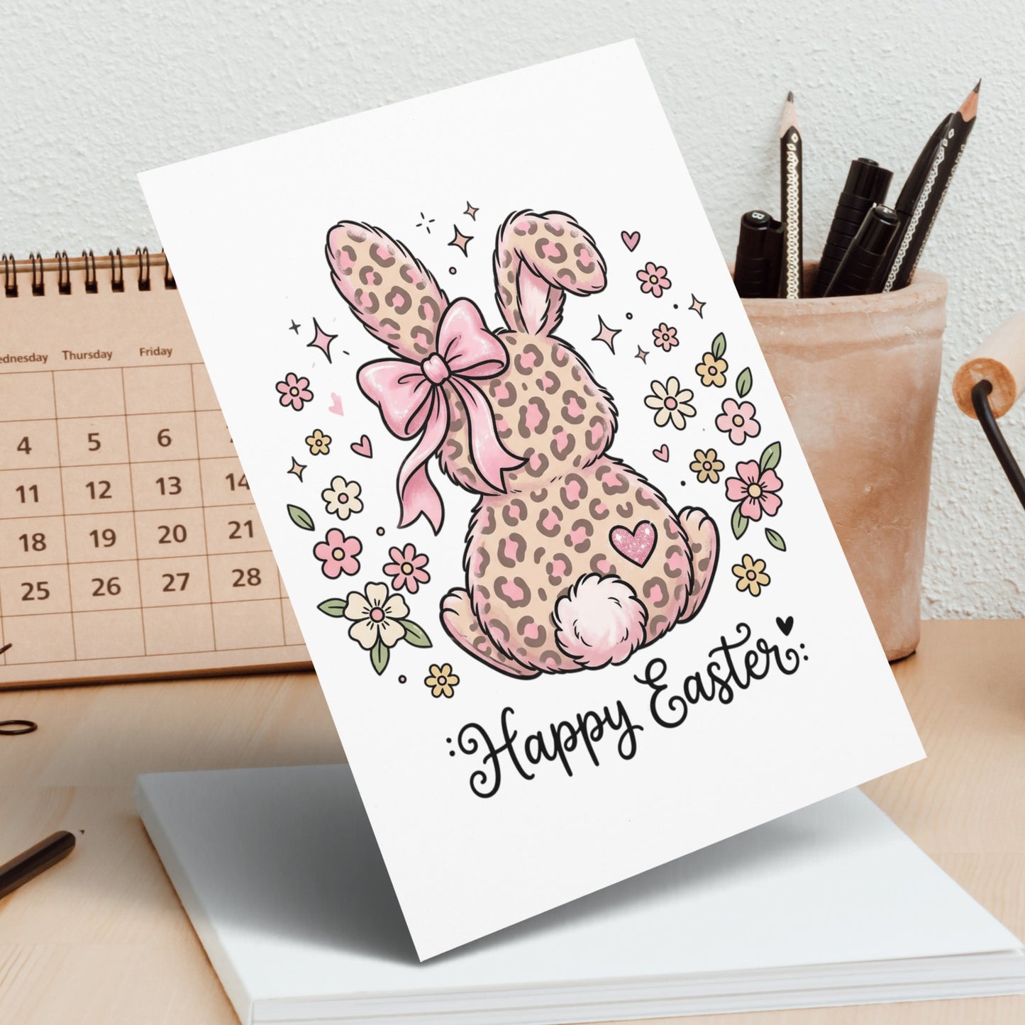 Leopard print Easter bunny card with pink bow, flowers, and "Happy Easter" text.