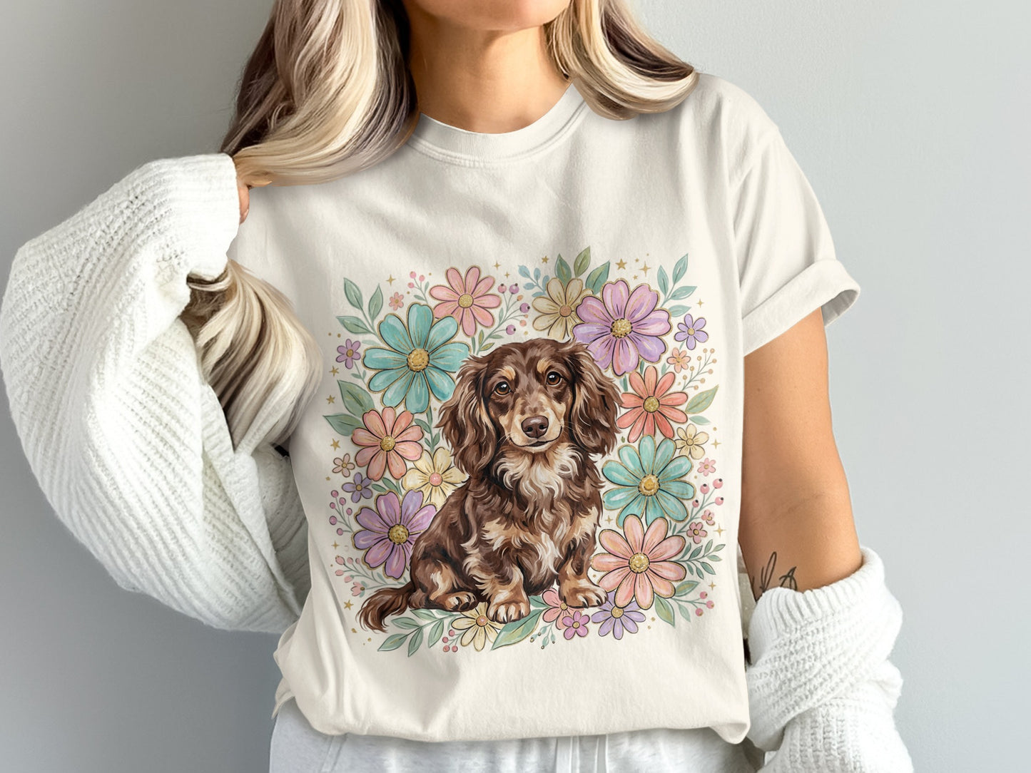 Dachshund in floral wreath on light t-shirt.