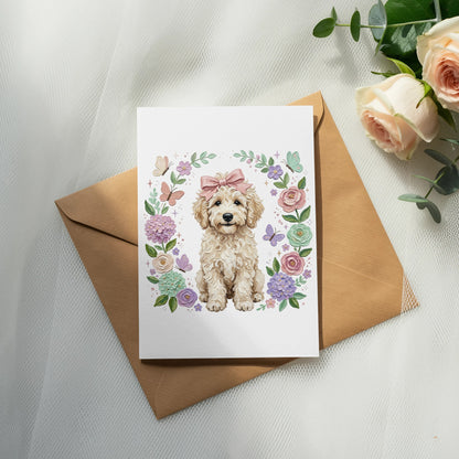 Fluffy dog with pink bow in floral wreath on a card.