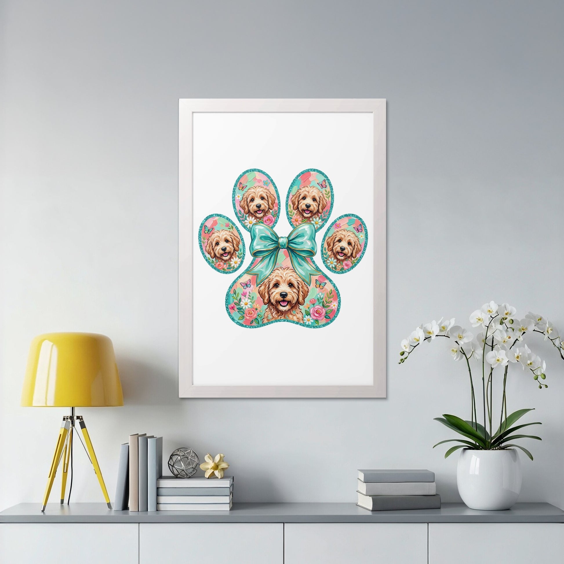 Framed paw print art with small dog faces and floral accents.