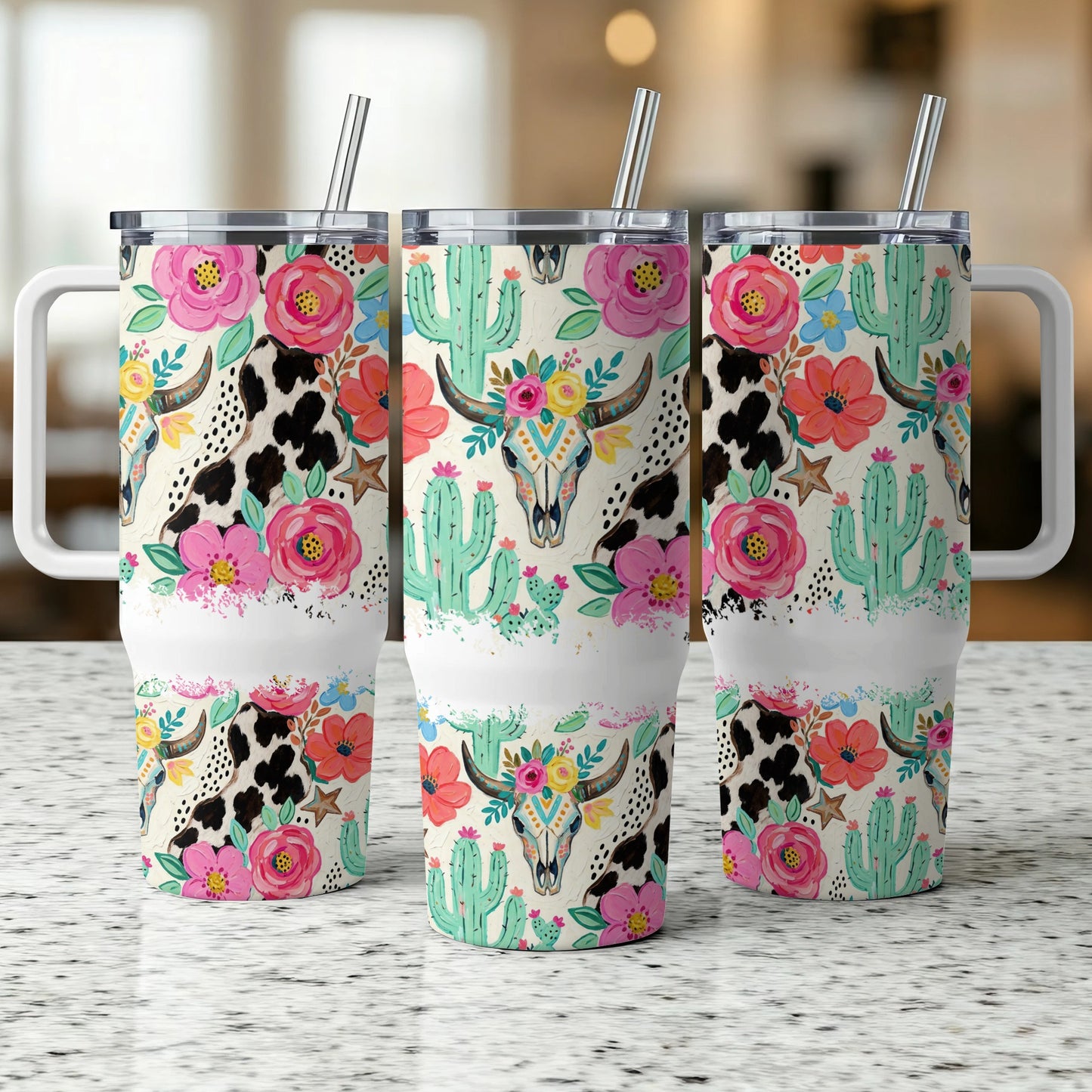 Three tumblers with cow print, cactus, and floral skull designs.