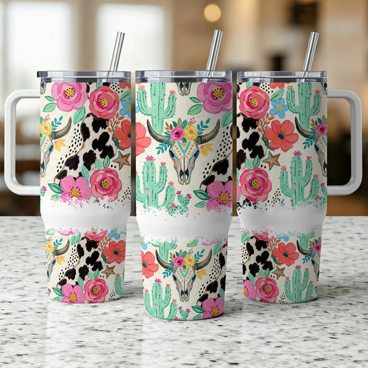 Three tumblers with cow print, cactus, and floral skull designs.