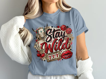 T-shirt graphic with bull skull, dice, cards, cherries, lips, and "Stay Wild" text.