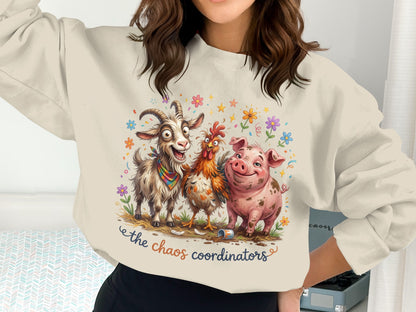 Goat, chicken, and pig cartoon characters on a cream sweatshirt with text.