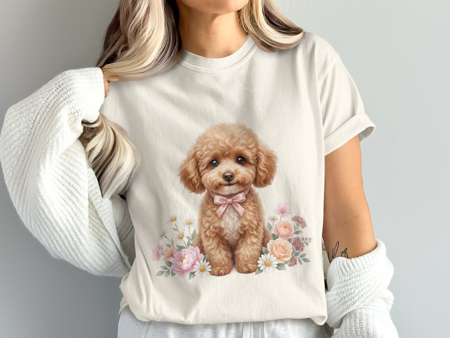 Cream t-shirt with illustration of a poodle wearing a pink bow and surrounded by flowers.