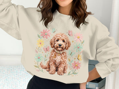 Cream sweatshirt with a doodle dog illustration surrounded by flowers and butterflies.