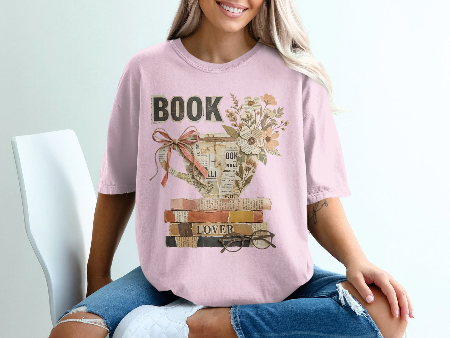 Pink t-shirt with a vintage watering can design overflowing with books and flowers.