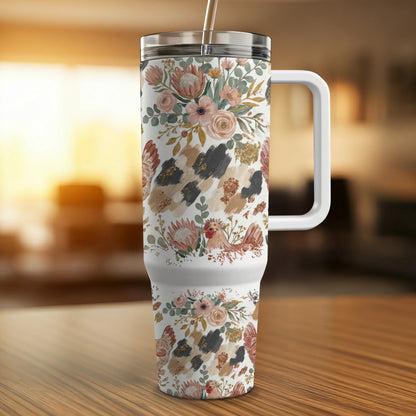 Floral and animal print insulated tumbler with a white handle.