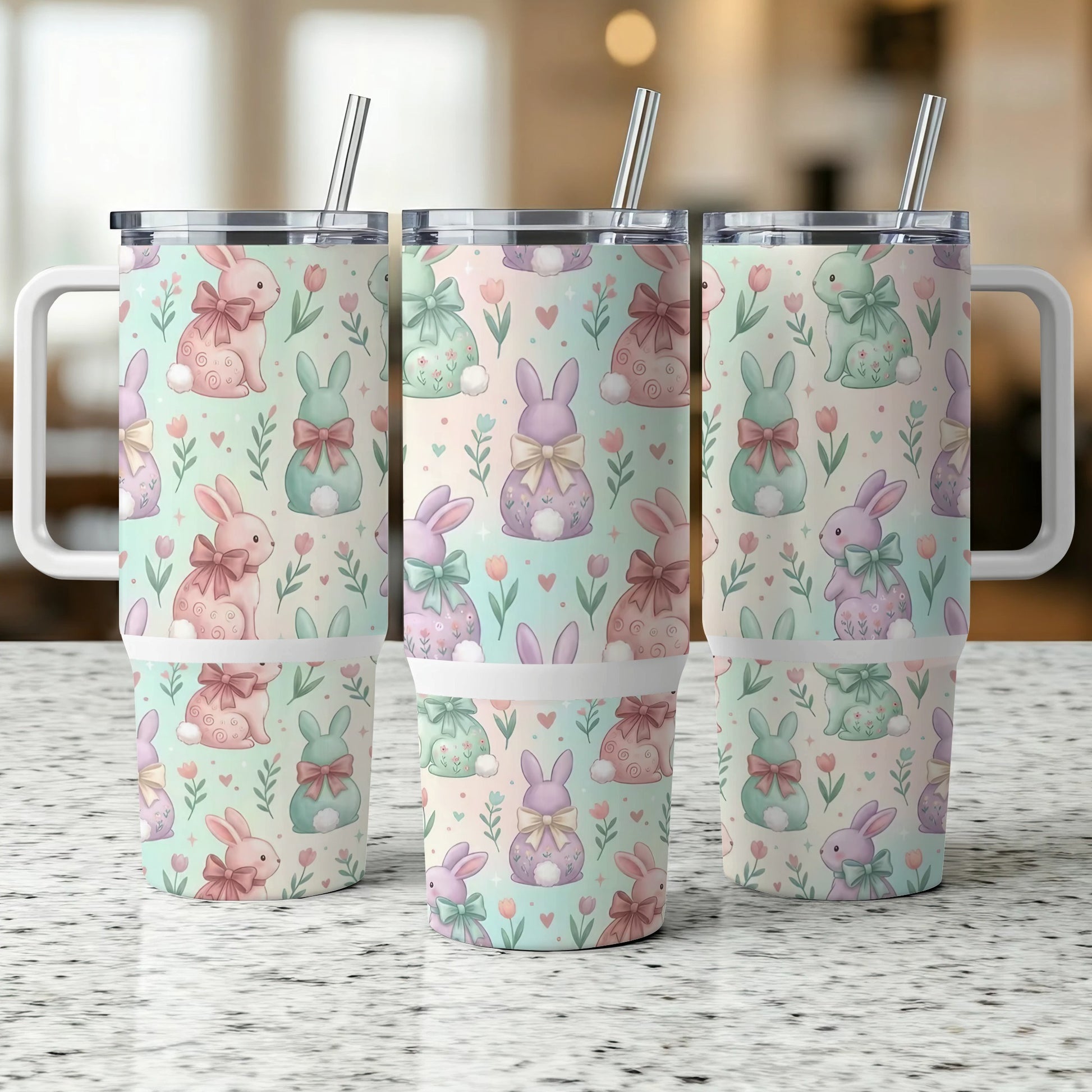 Three tumblers with pastel bunny and floral patterns and handles.