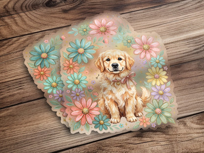 Golden Retriever puppy wearing a pink ribbon, surrounded by pastel flowers on a wooden background.