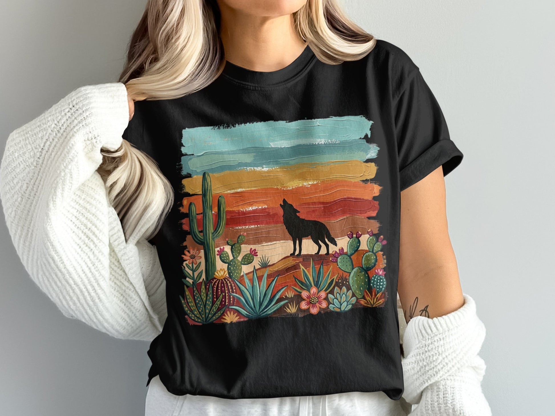Black t-shirt with desert landscape, cactus, and howling wolf silhouette.