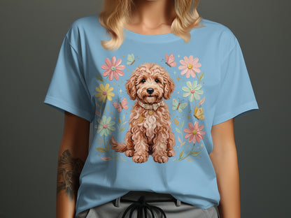 Light blue t-shirt featuring a cartoon doodle dog surrounded by flowers and butterflies.