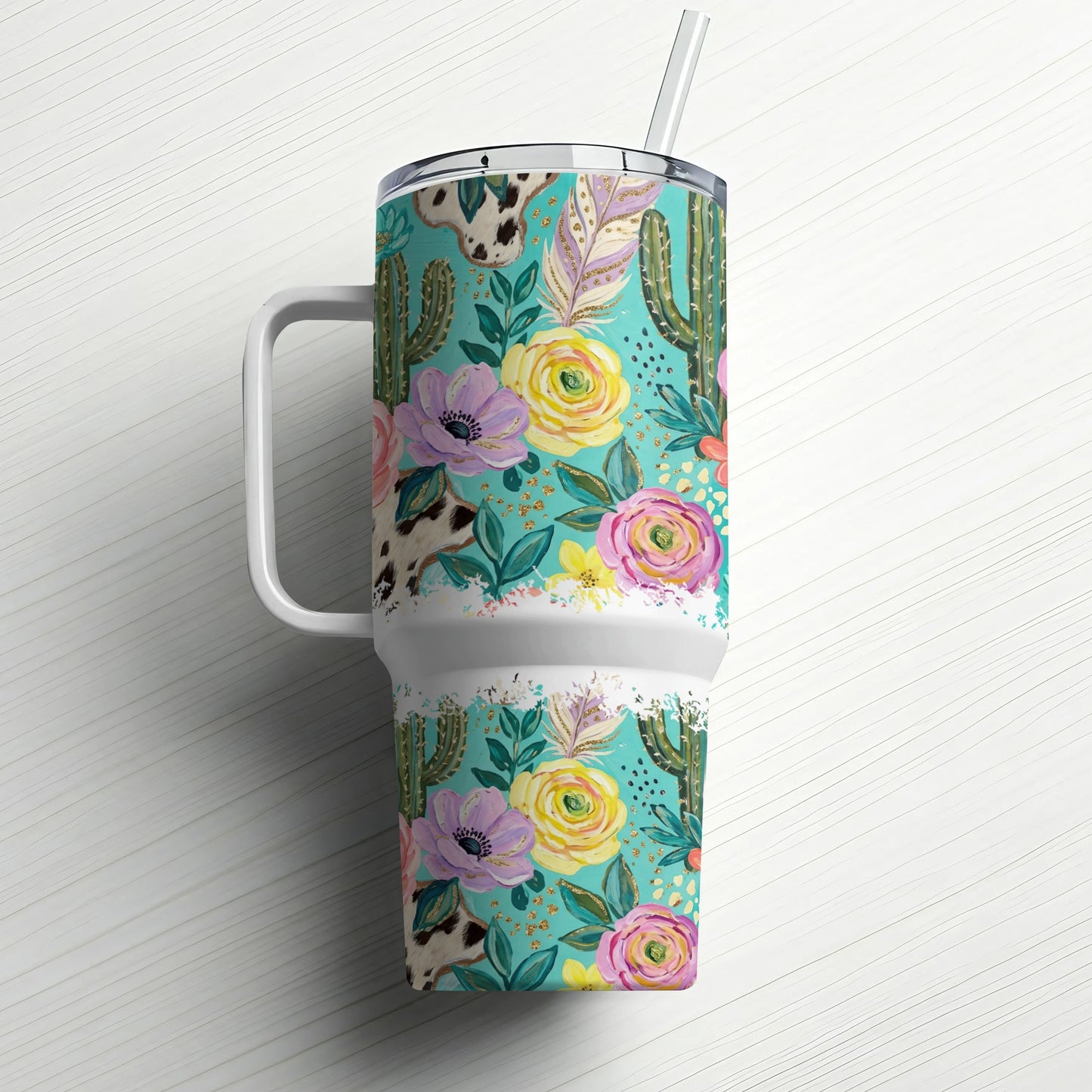 Floral and cactus pattern tumbler with a handle and straw.