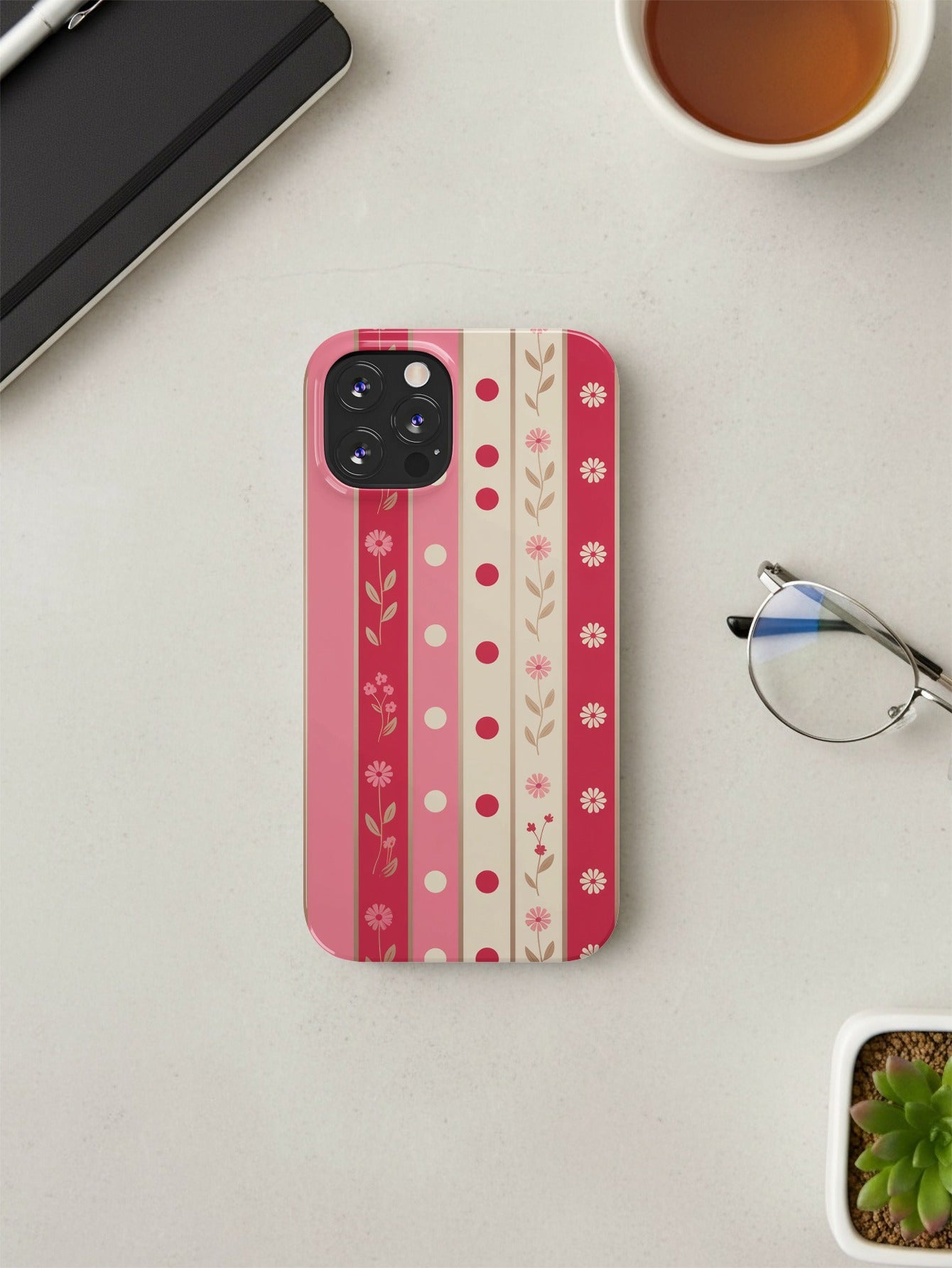 iPhone 14 Pro case with pink and cream floral stripe pattern.