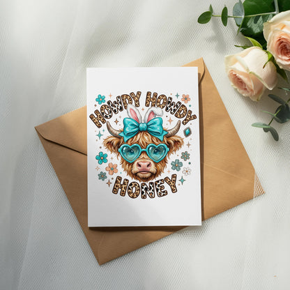Card with cartoon cow wearing heart sunglasses and "Howdy Howdy Honey" text.