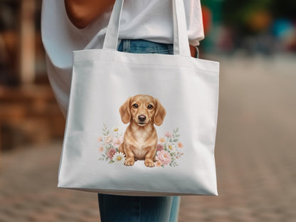 White tote bag with dachshund puppy illustration and floral accents.