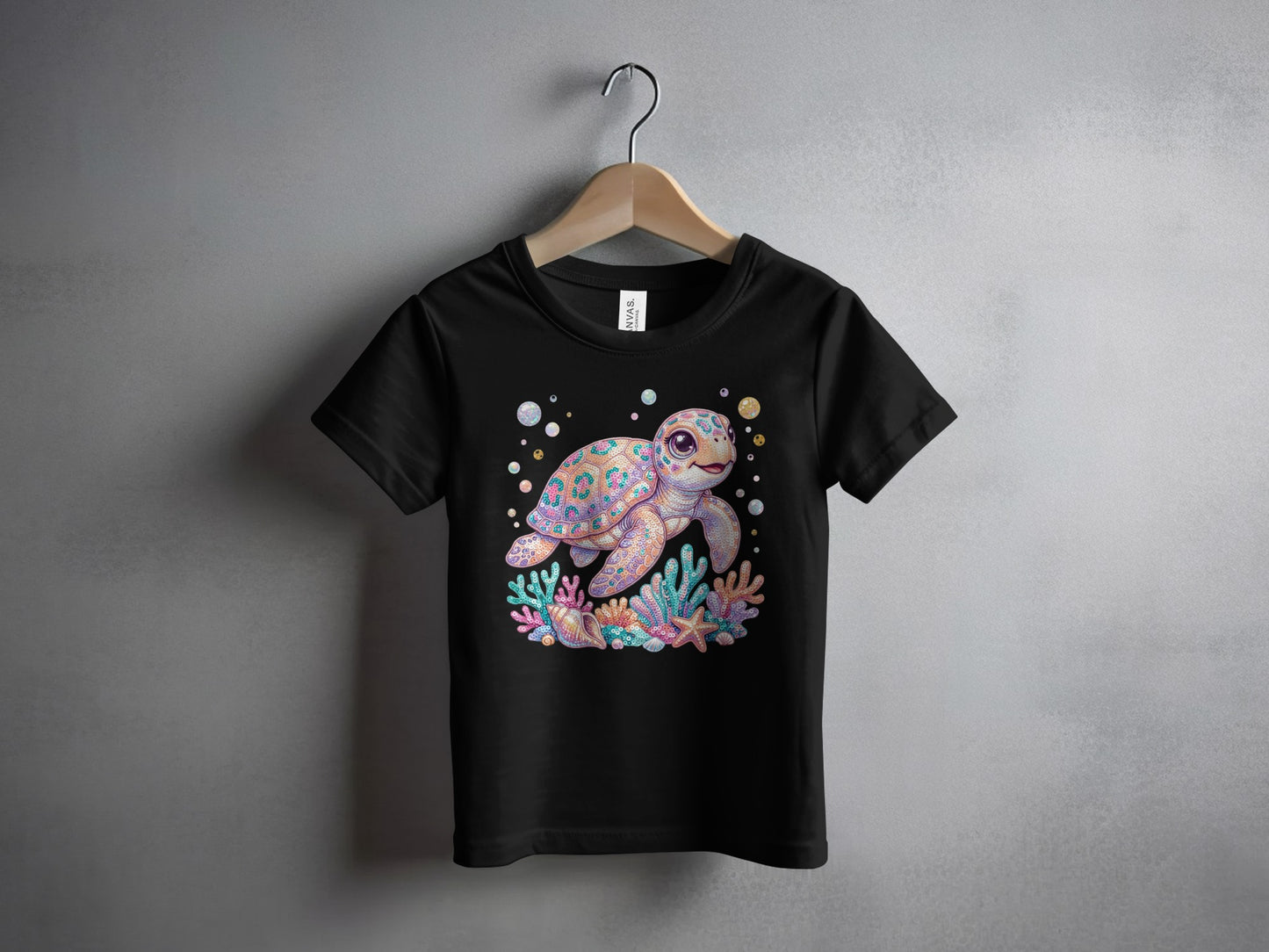 Black t-shirt with colorful cartoon sea turtle and coral reef graphic.