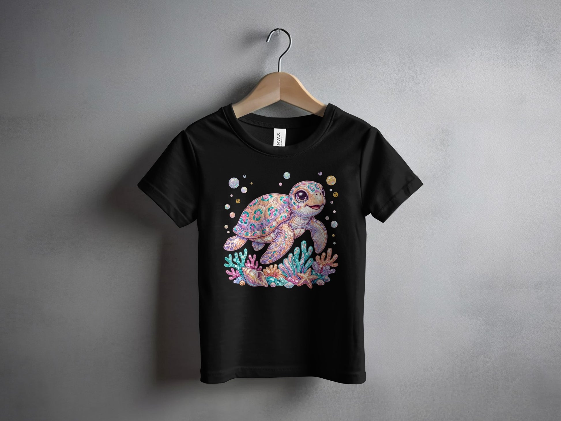 Black t-shirt with colorful cartoon sea turtle and coral reef graphic.