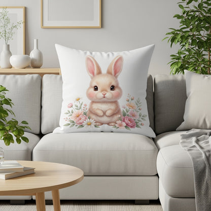 Fluffy bunny surrounded by flowers on a white throw pillow.