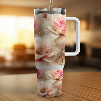 Floral tumbler with pink roses and leaves on a wooden surface.