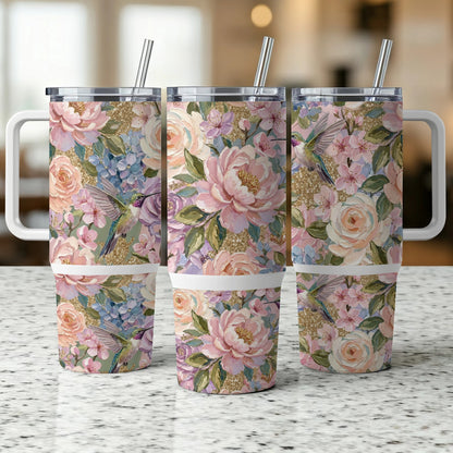 Floral tumbler with hummingbirds and gold glitter accents.