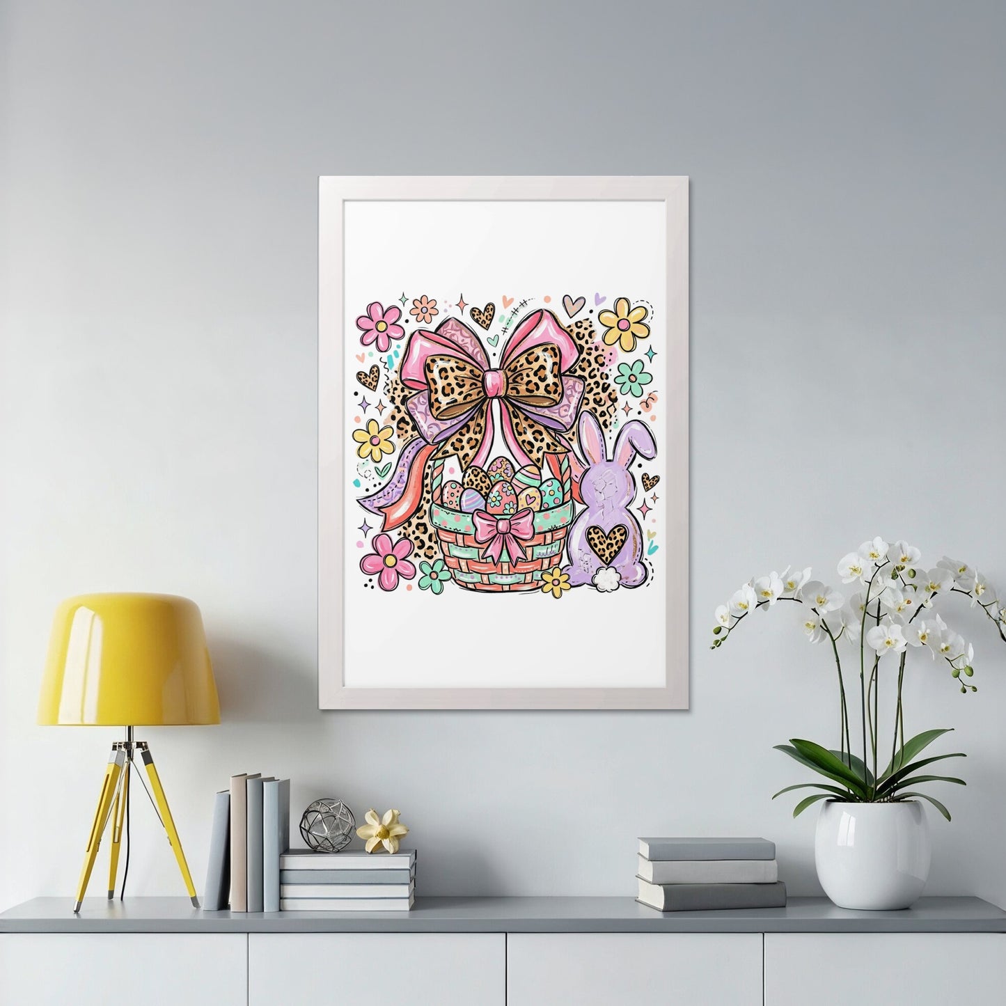 Easter basket with bunny, bow, and flowers in a white frame.