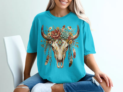 Turquoise t-shirt featuring a steer skull adorned with flowers and feathers.