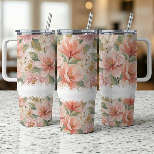 Three tumblers with a floral pattern of pink and white magnolias and greenery.