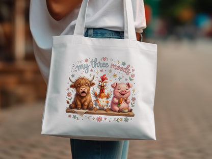 Cartoon highland cow, chicken, and pig wearing flower crowns on tote bag.