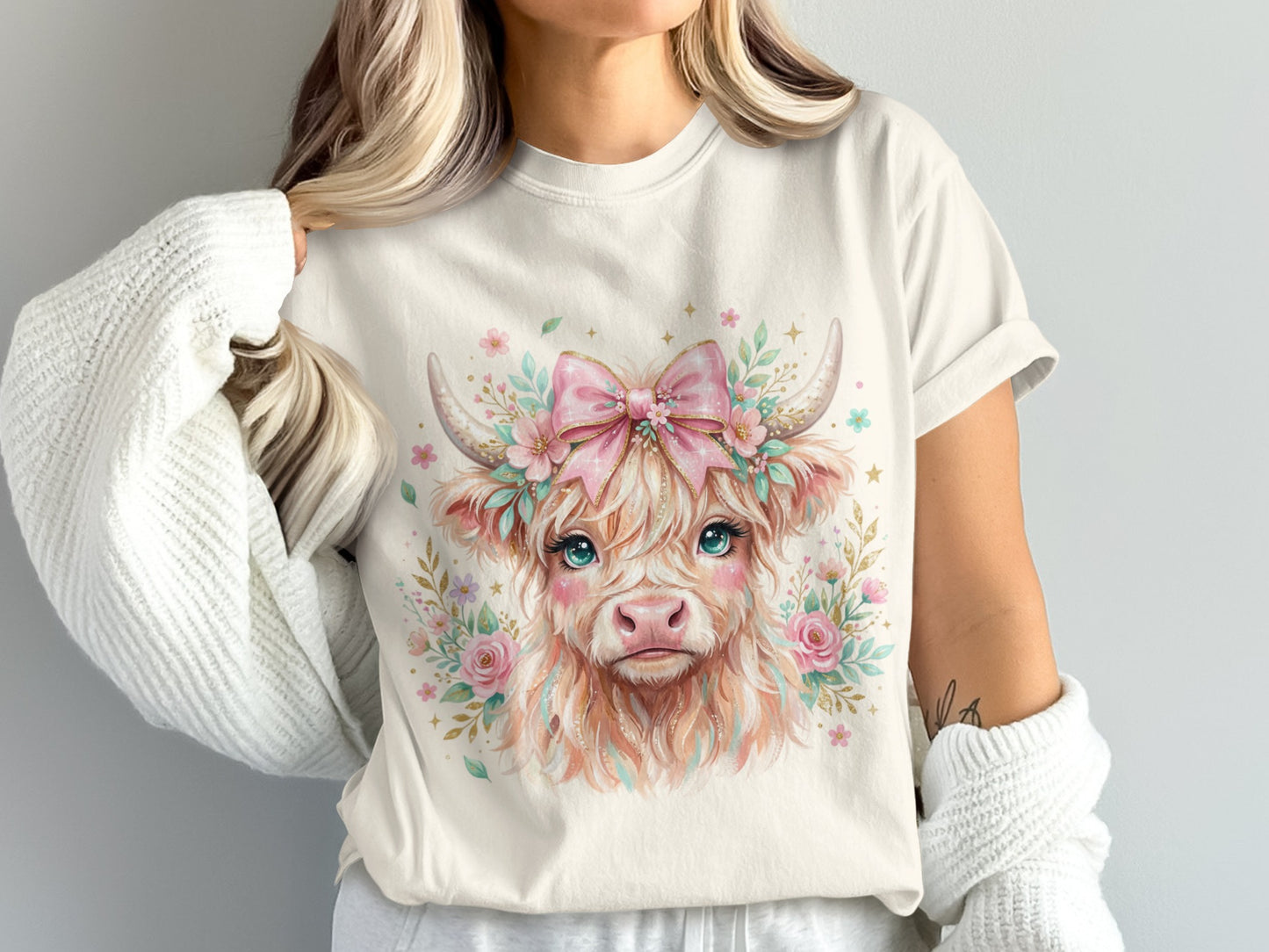 Watercolor Highland cow with pink bow and flowers on a white t-shirt.