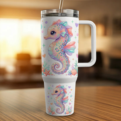 White travel mug with colorful seahorse and heart illustrations.