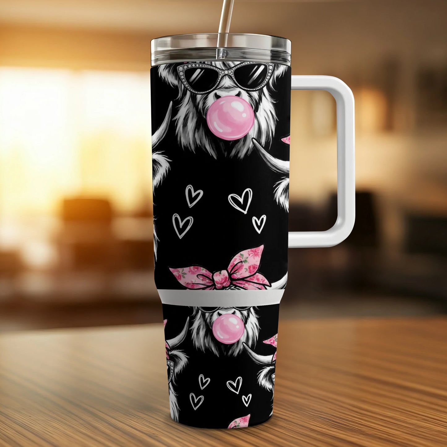 Highland cow wearing sunglasses and blowing bubblegum on a tumbler.