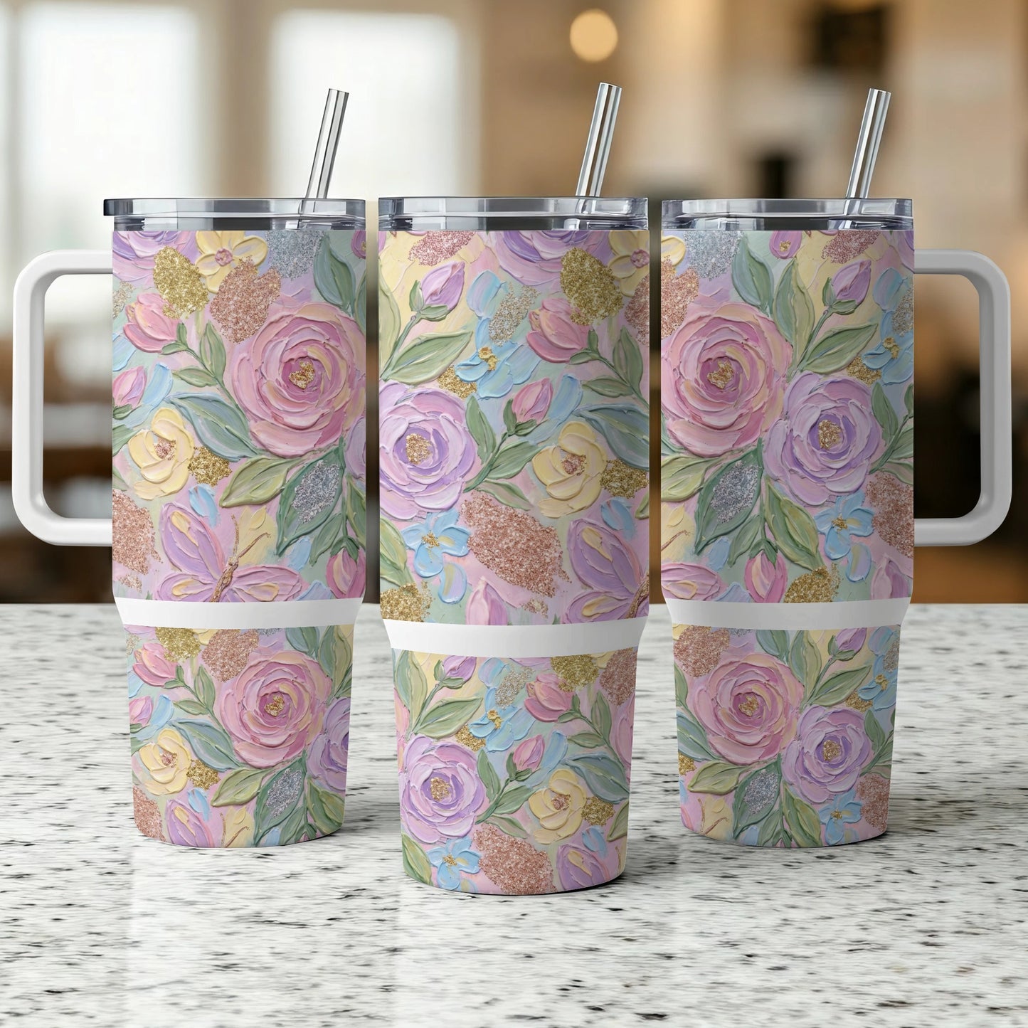 Three tumblers with pastel floral and glitter designs.