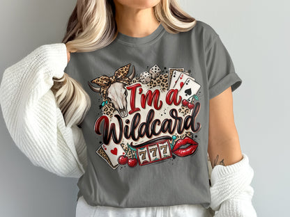 Woman wearing a grey t-shirt with a "I'm a Wildcard" graphic and casino imagery.
