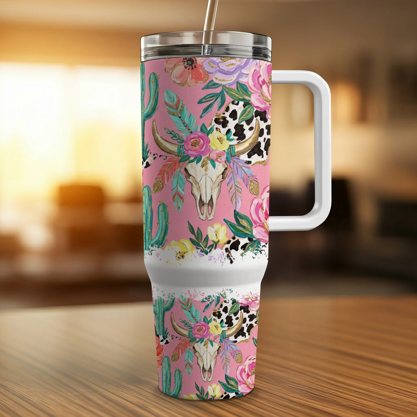 Pink tumbler with cow skull, cactus, and floral pattern.