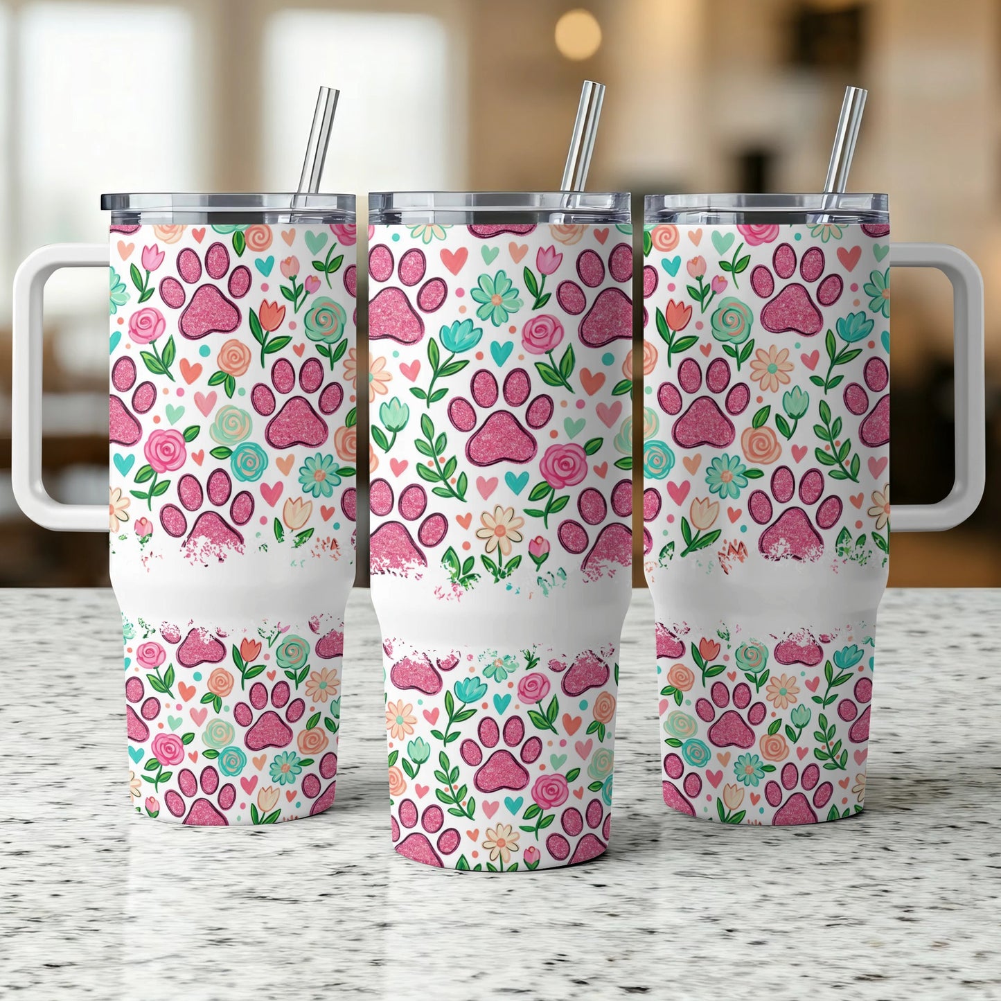 Three tumblers with pink paw print and floral pattern, featuring handles and straws.