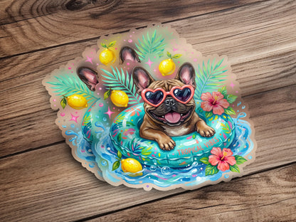 French bulldog in a float with heart sunglasses, lemons, and tropical flowers.