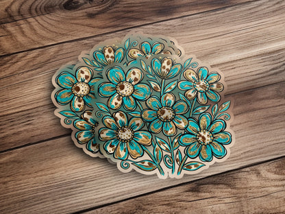 Bouquet of teal and gold floral stickers on wooden background.