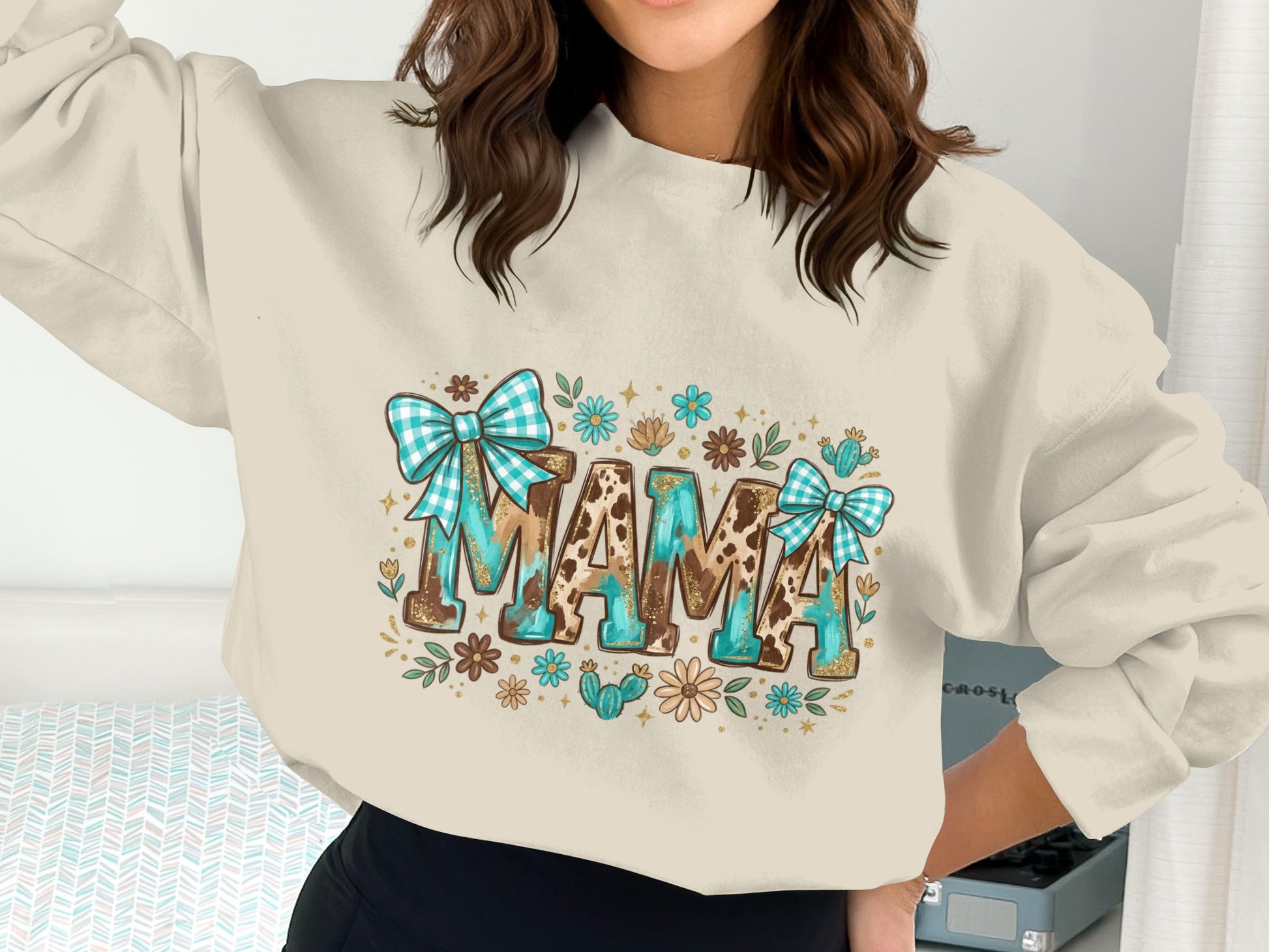 Cream sweatshirt with "MAMA" graphic, featuring blue gingham bows and floral accents.