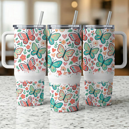 Three tumblers with floral and butterfly pattern and handles.