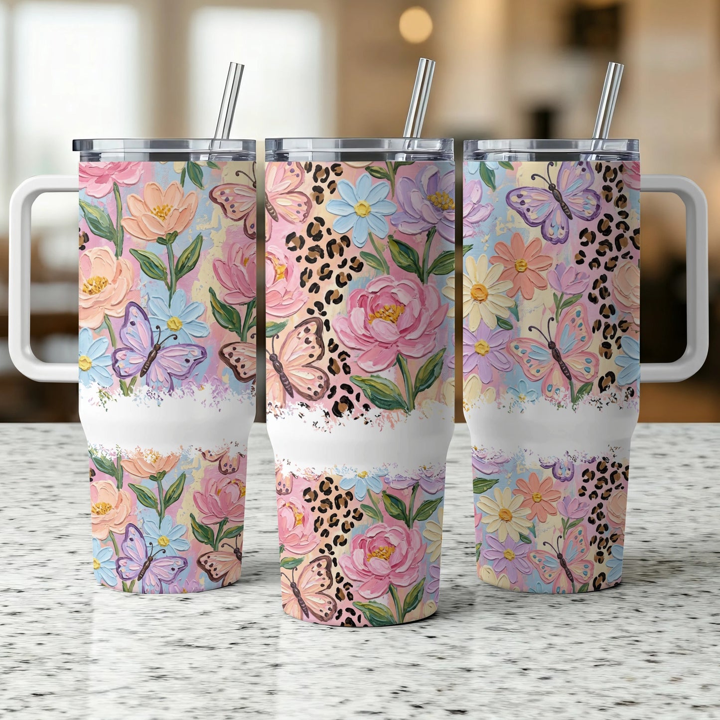 Three tumblers with floral and butterfly designs and leopard print accents.