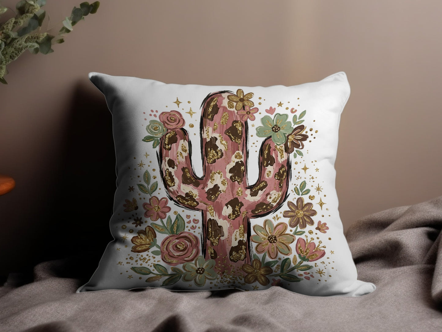 Cactus pillow with floral accents and gold glitter details.