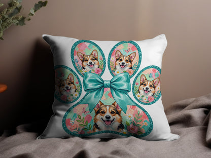Pillow with a paw print design featuring corgi faces and floral accents.
