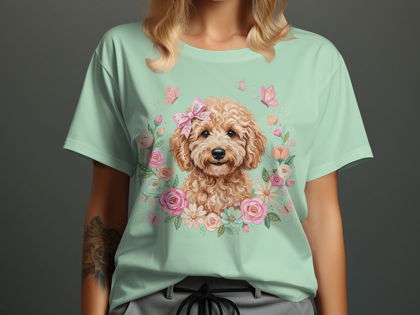 Light green t-shirt featuring a smiling golden doodle with flowers and butterflies.