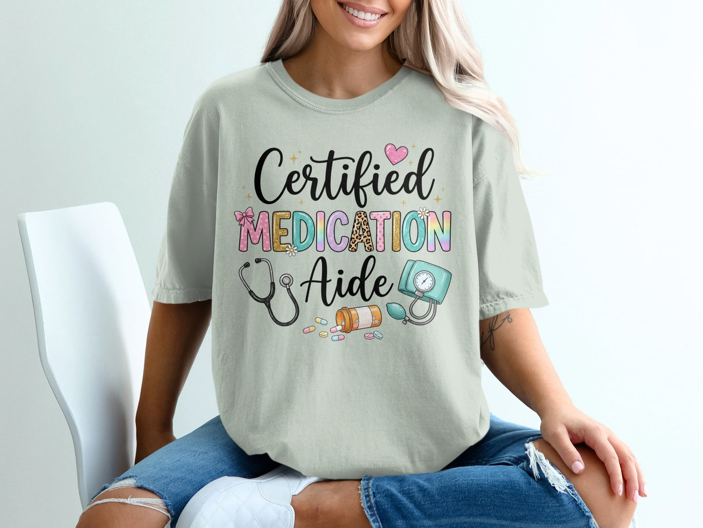 T-shirt with "Certified Medication Aide" text and medical icons.