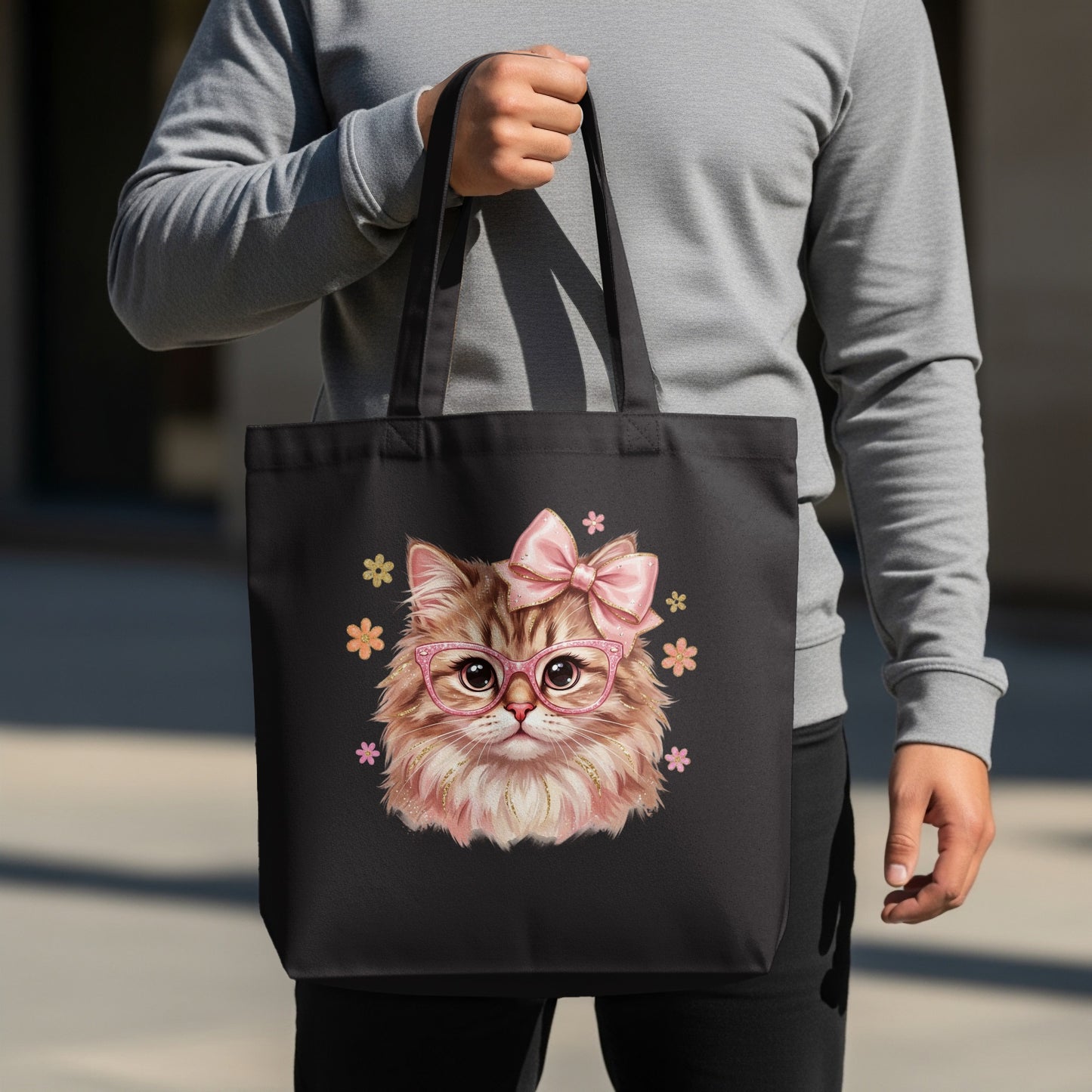 Black tote bag featuring a fluffy cartoon cat wearing glasses and a pink bow.
